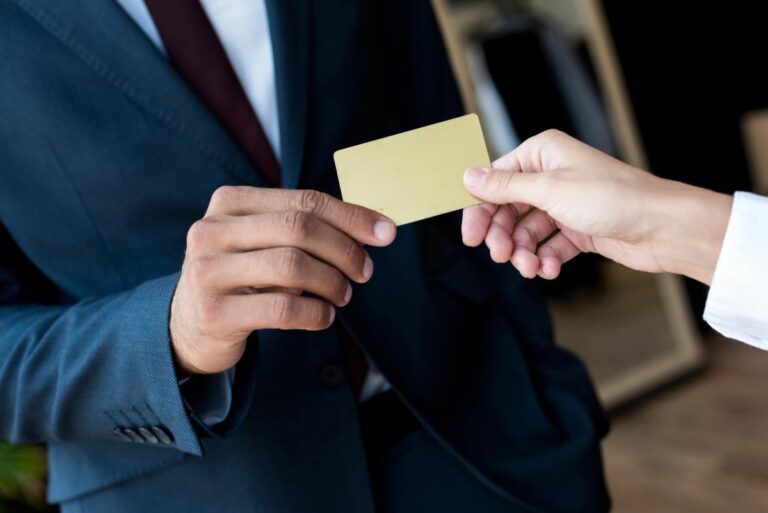 Business person handing another their business card