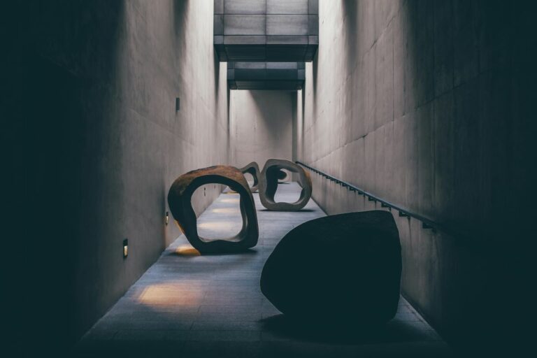A series of large stone objects in a hallway representing the obstacles in career development programmes that organisations face