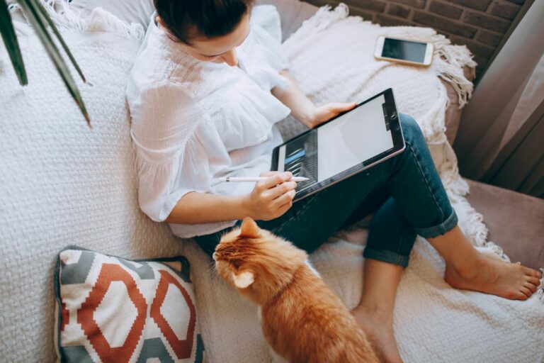 Trends in Career Development and How Organisations Can Adapt - woman sat on sofa working from home with a cat