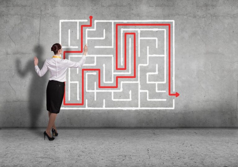 woman with a maze drawing a wiggly line through the maze representing How to Engage High-Potential Talent When Roles Are Limited with non-linear moves.